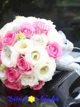 Bó hoa cưới cầm tay cô dâu hồng cánh sen và cát tường trắng